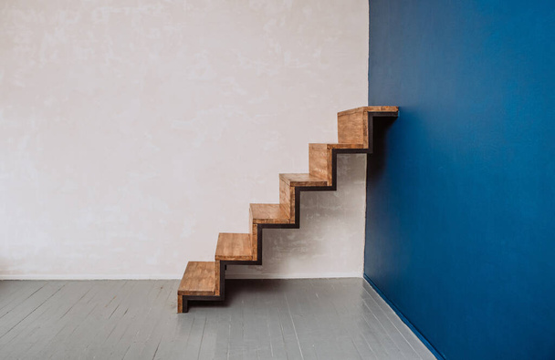 loft style staircase metal and wood in the corner with blue wal - Foto, Bild