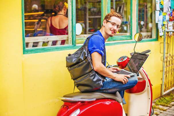 Man with laptop on motorbike - 写真・画像