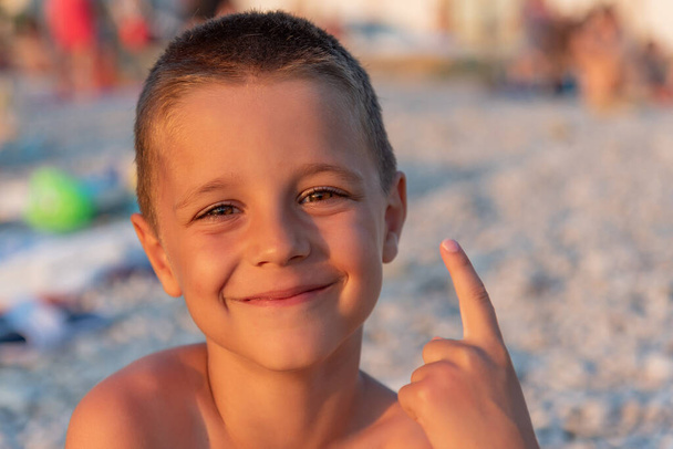 A nice boy on the beach at sunset - Photo, Image
