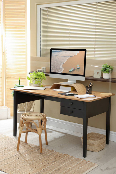 Light room interior with comfortable workplace near window - Foto, imagen