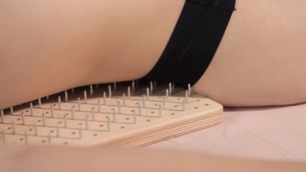 Woman lying on a board with nails - Footage, Video