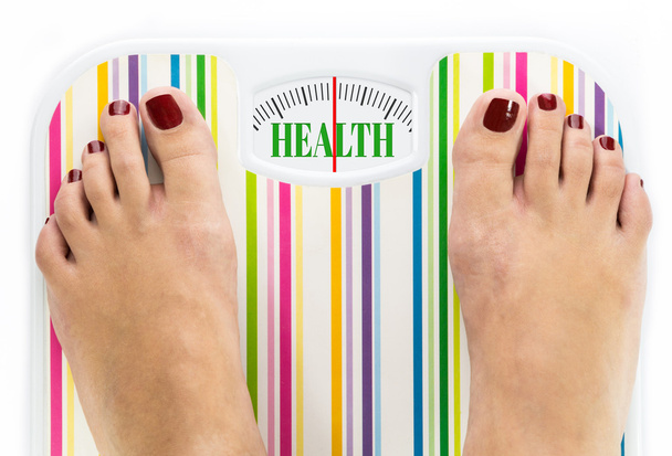 Feet on bathroom scale with word "Health" on dial - Photo, Image