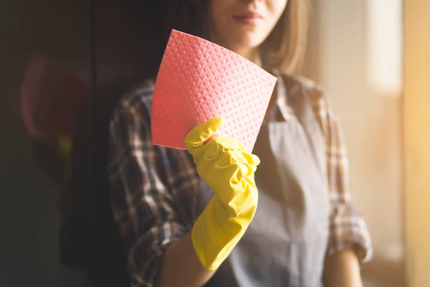 A woman in yellow rubber gloves does housework - Photo, Image