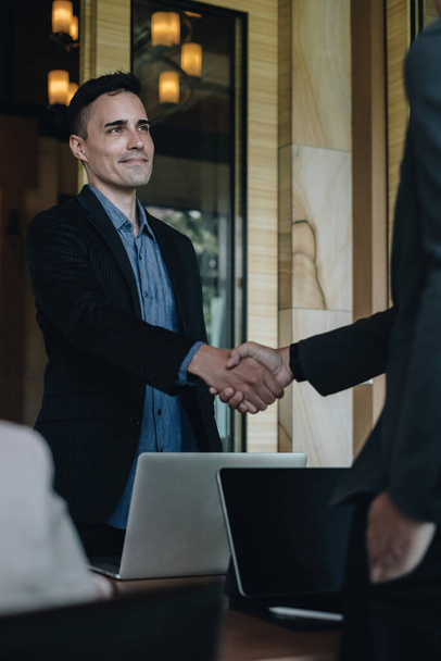 Businessman and partner handshake for the new agreement after sign in agreement contract with work together. - Photo, Image