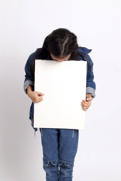 The Asian girl standing on the white background. - Valokuva, kuva