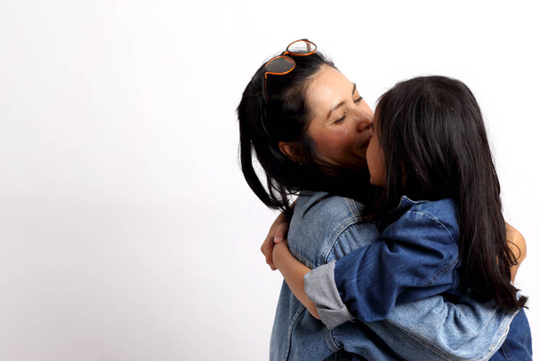The Asian woman with her daughter in the white background. - Foto, Imagem