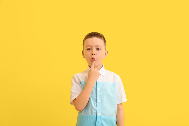 Little boy training pronounce letters on color background - Photo, Image