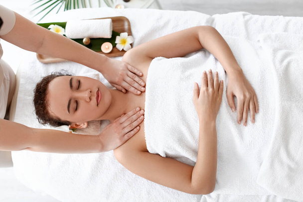 Beautiful young African-American woman getting massage in spa salon - Φωτογραφία, εικόνα