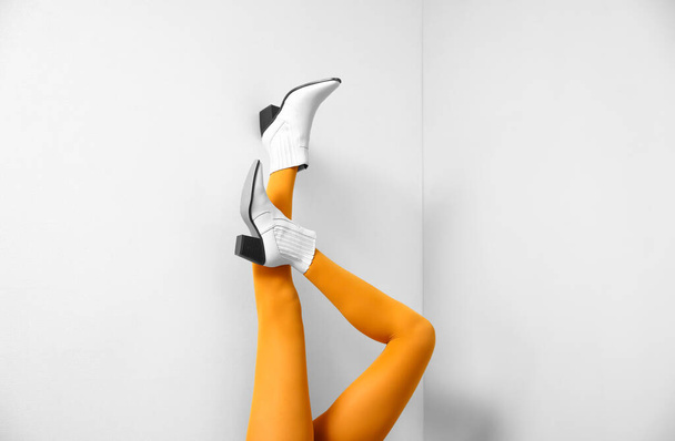 Legs of stylish young woman near light wall - Foto, Imagem