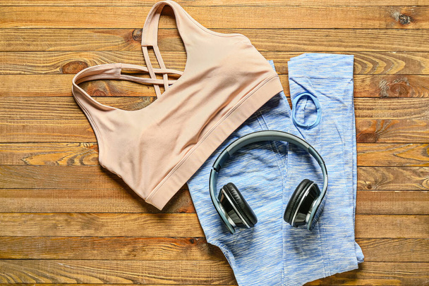 Sportswear and headphones on wooden background - Photo, Image