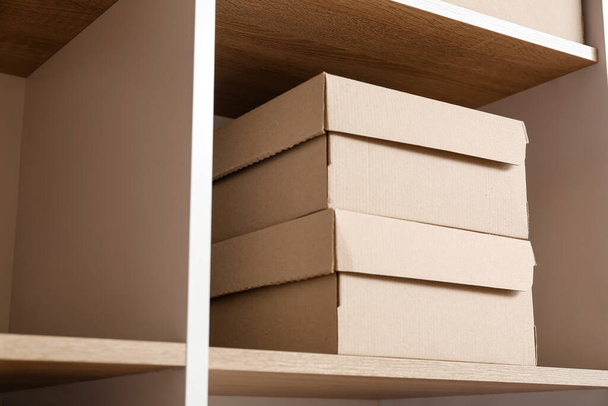 Cardboard boxes on shelf in wardrobe - Fotó, kép