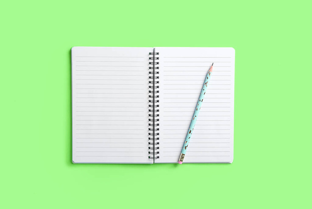 Otwarty notatnik i ołówek na tle koloru - Zdjęcie, obraz