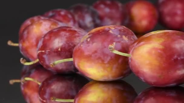 Plums in a row on mirror. Rotation with acceleration. Side view. 4K UHD video footage 3840X2160. - Footage, Video