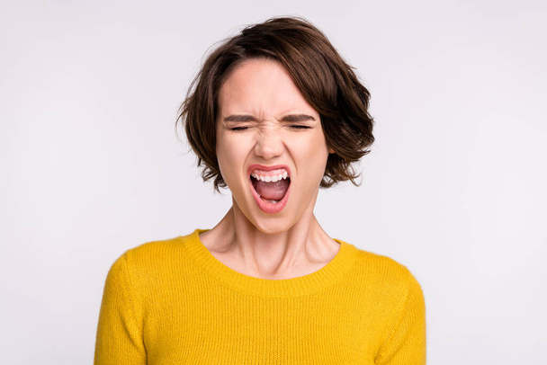 Photo of aggressive girl close eyes scream open mouth wear yellow shirt isolated grey color background - Photo, Image
