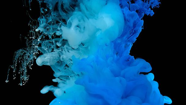 Cosmic magic background. Blue watercolor ink in water on a black background. Waves and drops of blue paint. Beautiful abstract background. Blue cloud of ink. - Foto, imagen