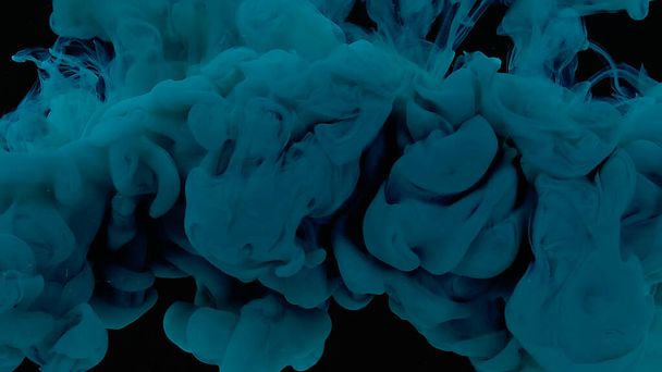 Cosmic magic background. Blue watercolor ink in water on a black background. Waves and drops of blue paint. Beautiful abstract background. Blue cloud of ink. - Foto, Imagen