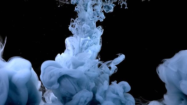 Blue-gray ink cloud. Waves and drops of blue-gray colors. Beautiful abstract background. Amazing space magic background. Light blue-gray watercolor ink in water on a black background. - Фото, зображення