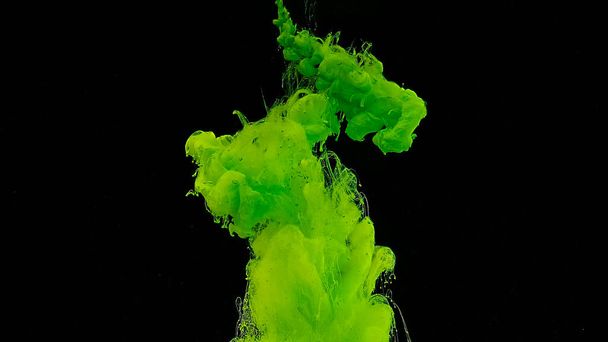 Waves and drops of green colors. Cosmic magic background. Beautiful abstract background. Green watercolor ink in water on a black background. - Foto, immagini
