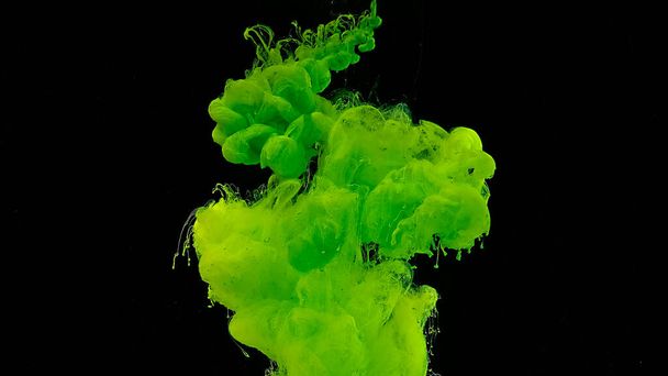 Cosmic magic background. Beautiful abstract background. Green watercolor ink in water on a black background. Waves and drops of green colors. - Foto, Bild