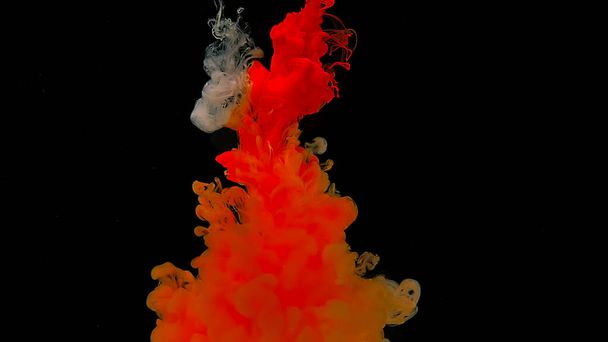 Beautiful abstract background. Amazing space magic background. Orange watercolor ink in water on a black background. Orange cloud of ink. Waves and drops of orange paints. - Foto, Bild