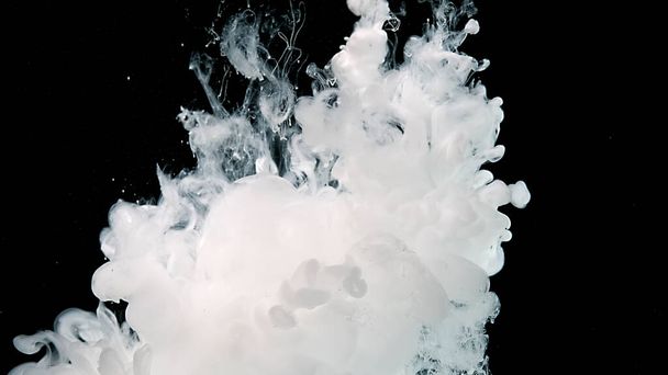 White cloud of ink on a black background. White watercolor paints in water. Cosmic magic abstract background. - Fotografie, Obrázek
