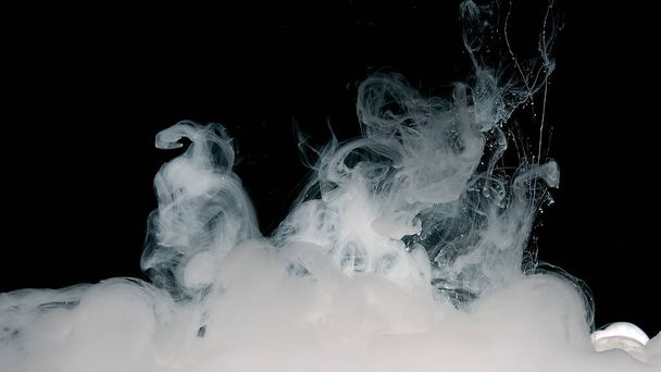 Meditative magic abstract background. White cloud of ink on a black background. White watercolor paints in water. - Foto, immagini
