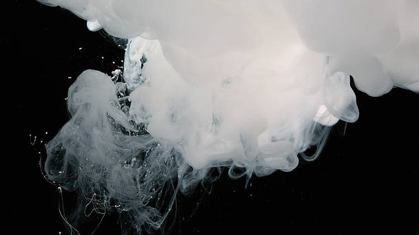 White watercolor paints in water. White cloud of ink on a black background. - Foto, Imagen