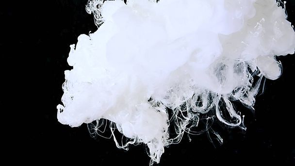 White cloud of ink on a black background. Cosmic magic abstract background. White watercolor paints in water. Drops of white ink in water. - Fotoğraf, Görsel