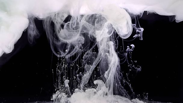 Cosmic magic background. White cloud of ink. Waves and drops of white paints. White abstract background. White watercolor ink in water on a black background. - Фото, изображение