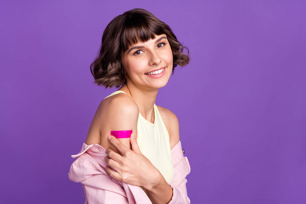 Photo of positive happy young woman vaccine shoulder patch smile isolated on purple color background - Valokuva, kuva