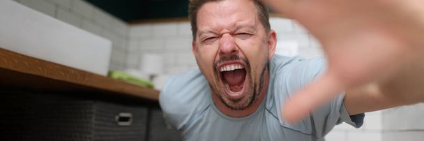 Man sitting on toilet and screaming in pain - Photo, Image