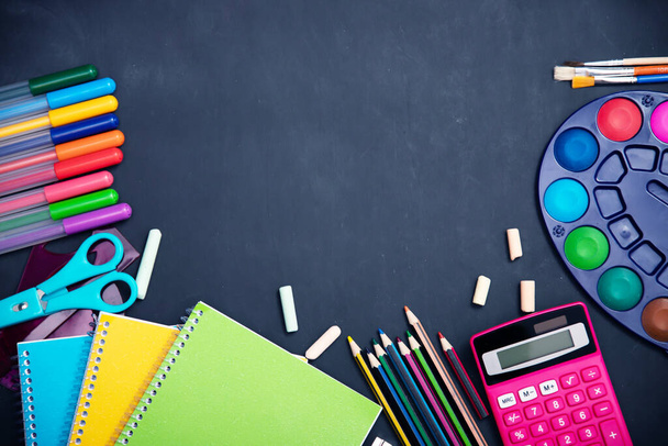 Education, back to school concept. School supplies on blackboard with copy space. - Foto, Imagem
