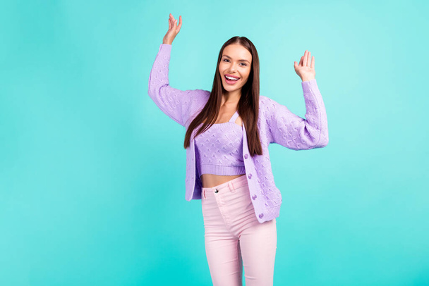 Photo of funky shiny young woman dressed purple clothes dancing smiling isolated teal color background - Foto, afbeelding