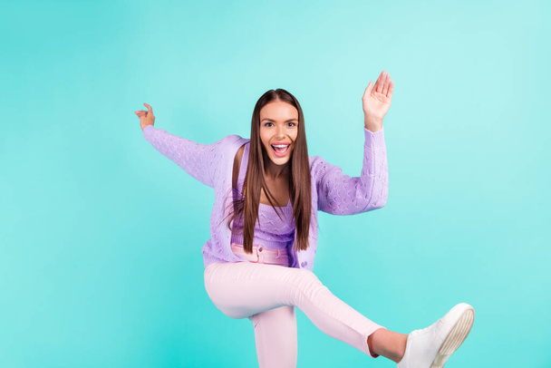 Photo of charming sweet young lady wear violet outfit smiling dancing isolated turquoise color background - Φωτογραφία, εικόνα