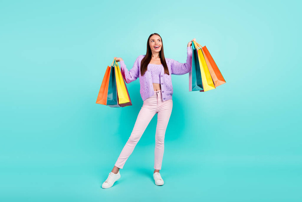 Photo of pretty dreamy lady wear violet outfit holding shopping bargains looking empty space isolated turquoise color background - Foto, Bild