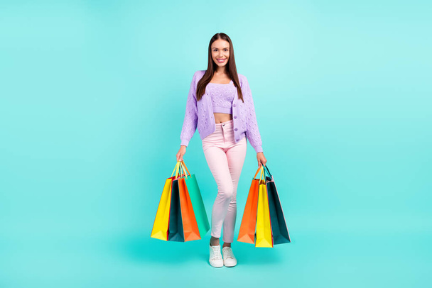 Photo of positive nice client store lady hold shop packages wear purple cardigan isolated turquoise color background - Fotoğraf, Görsel