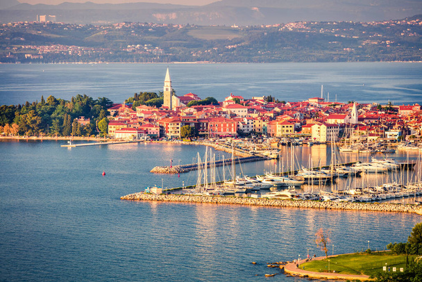 Aerial view of old fishing town Izola. Colorful spring evening on Adriatic Sea. Beautiful seascape of Slovenia, Europe. Beauty of countryside concept background. Artistic style post processed photo. - Photo, Image