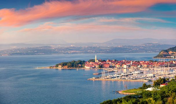 Aerial view of old fishing town Izola. Impressive spring sunset in Slovenia, Europe. Beautiful seascape Adriatic Sea. Traveling concept background - Photo, Image