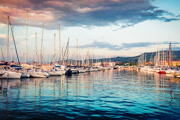 Great summer sunset in port of old fishing town Izola. Colorful spring evening on Adriatic Sea. Beautiful seascape of Slovenia, Europe. Traveling concept background. - Photo, Image