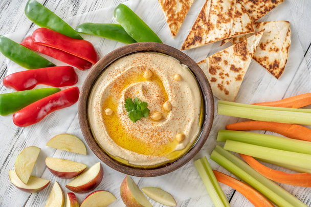 Bowl of hummus garnished with olive oil and paprika - Photo, Image