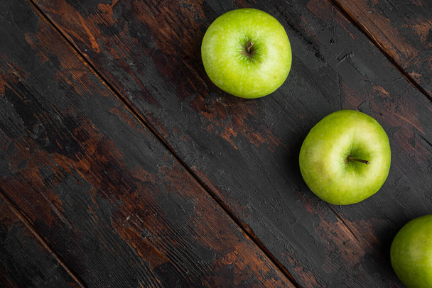Ripe green apples set, on old dark rustic table background, top view flat lay, with copy space for text - Photo, image