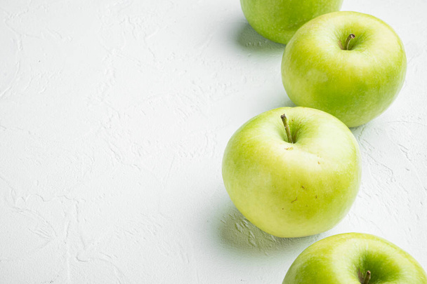 Green apple set, on white stone table background, with copy space for text - Photo, Image