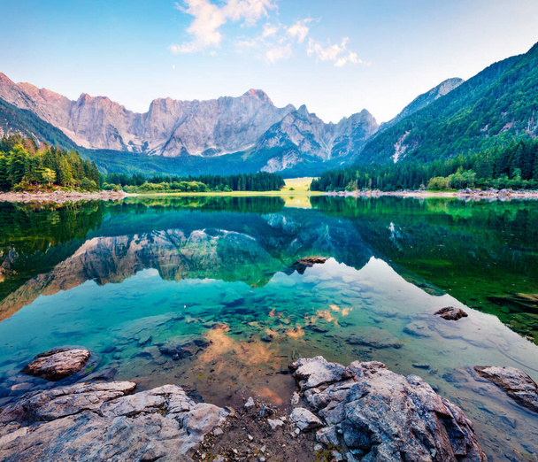 Julian Alps in the morning mist. Amazing summer view of Fusine lake. Majestic outdoor scene with Mangart peak on background, Province of Udine, Italy, Europe. Traveling concept background. - Photo, Image