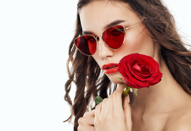 красивая женщина в солнечных очках с розой в руках голыми плечами - Фото, изображение