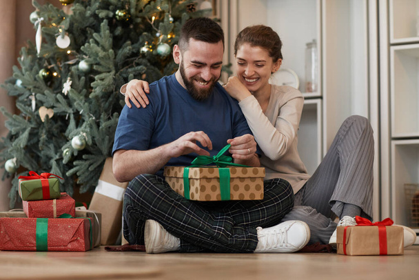 Man Unwrapping Present From Girlfriend - Photo, Image