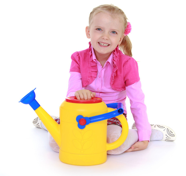 girl holding a garden watering can. - 写真・画像