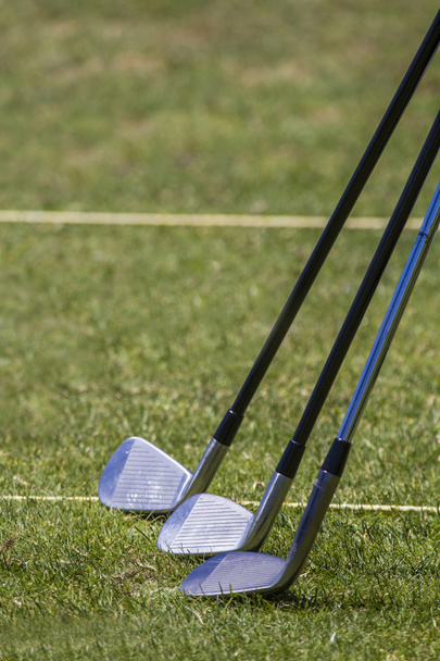 Golf clubs on a golf course field - Photo, Image
