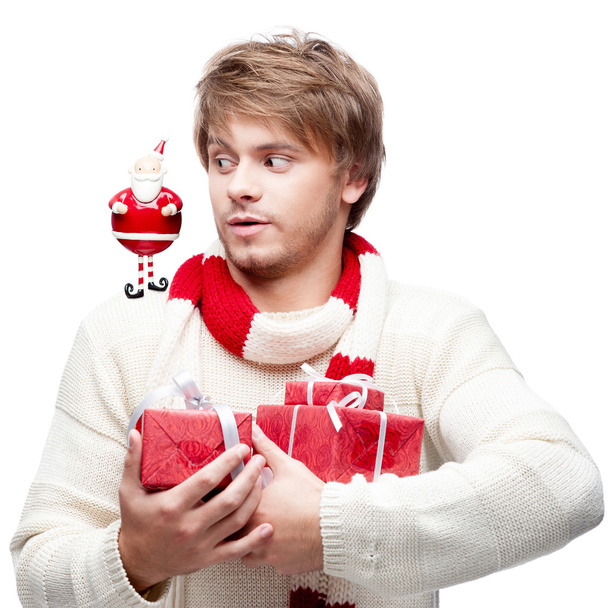 young funny man holding christmas gifts - Fotó, kép
