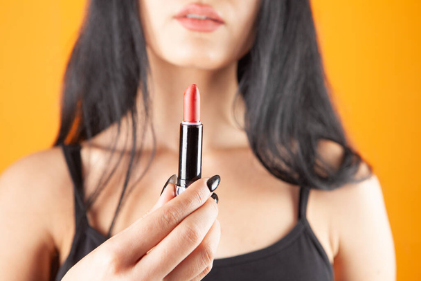 young woman paints her lips with lipstick - 写真・画像