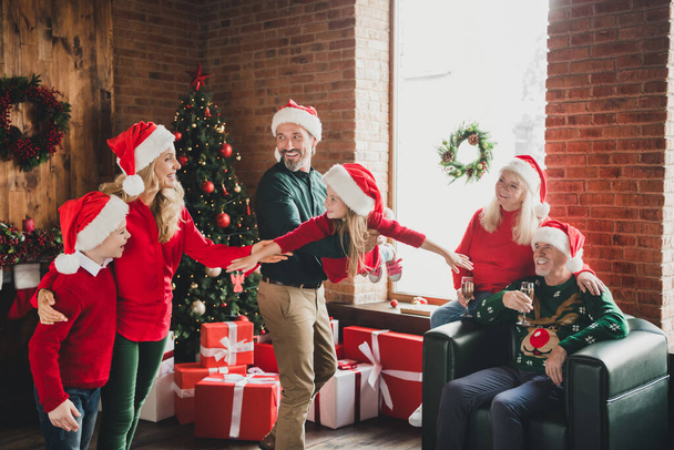 Photo of friends childhood grandparents retired pensioner grandchildren husband wife play wear santa claus hat noel in house indoors - Photo, image